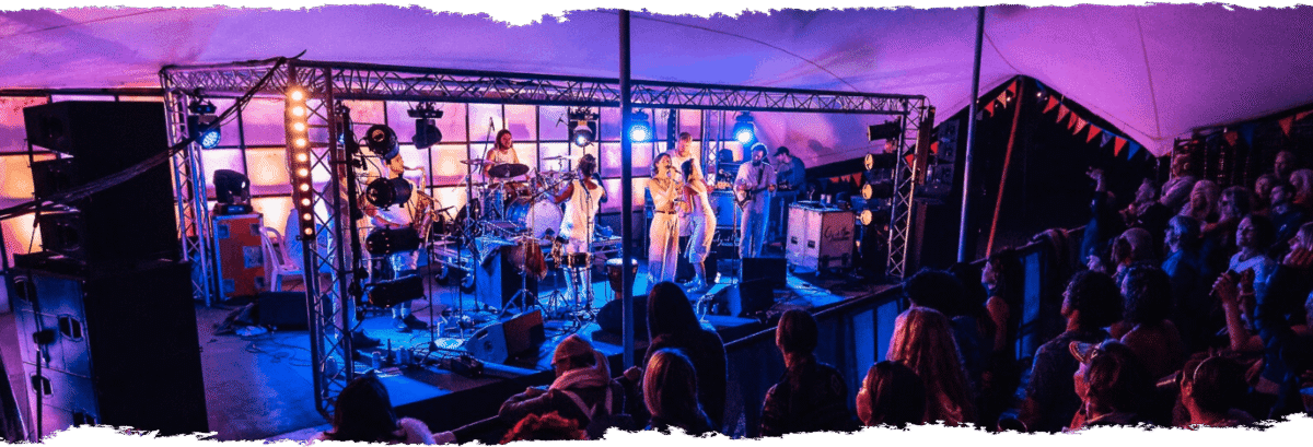 Purple lighting on stage with performers