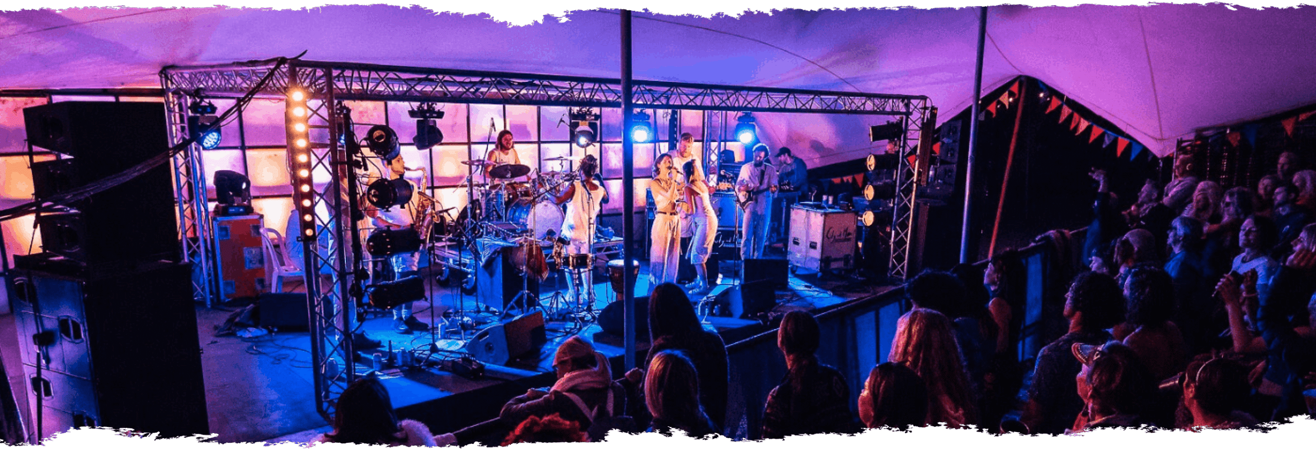 Purple lighting on stage with performers