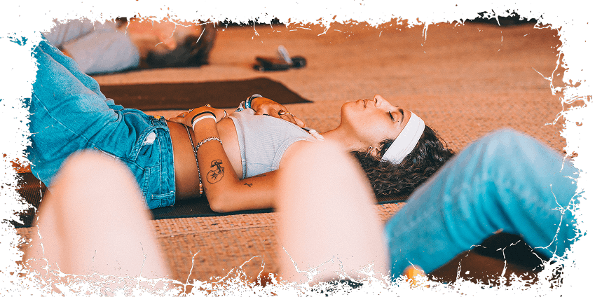 Woman lying down performing breathing exercises